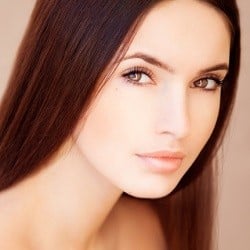 woman with clear skin in pink background