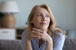 senior mature blonde woman leaning chin on hands